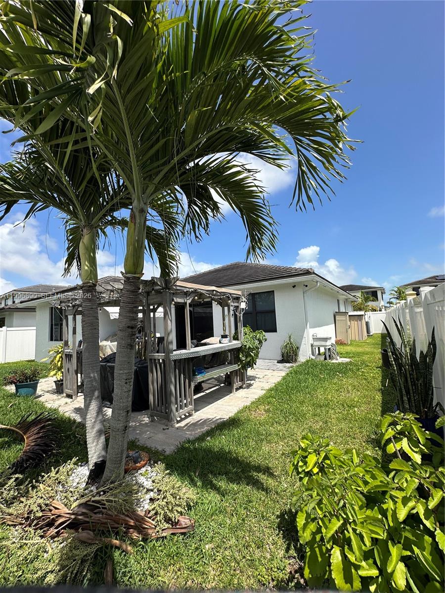23552 Southwest 107th Place Homestead, FL 33032 - Photo 28 of 30 a front view of a house with a yard