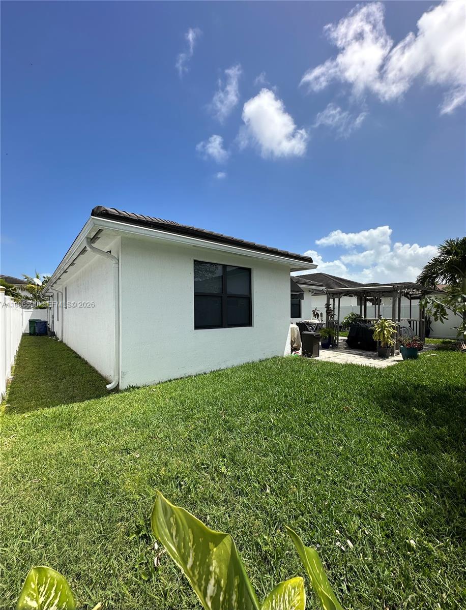 23552 Southwest 107th Place Homestead, FL 33032 - Photo 29 of 30 a house view with a garden space