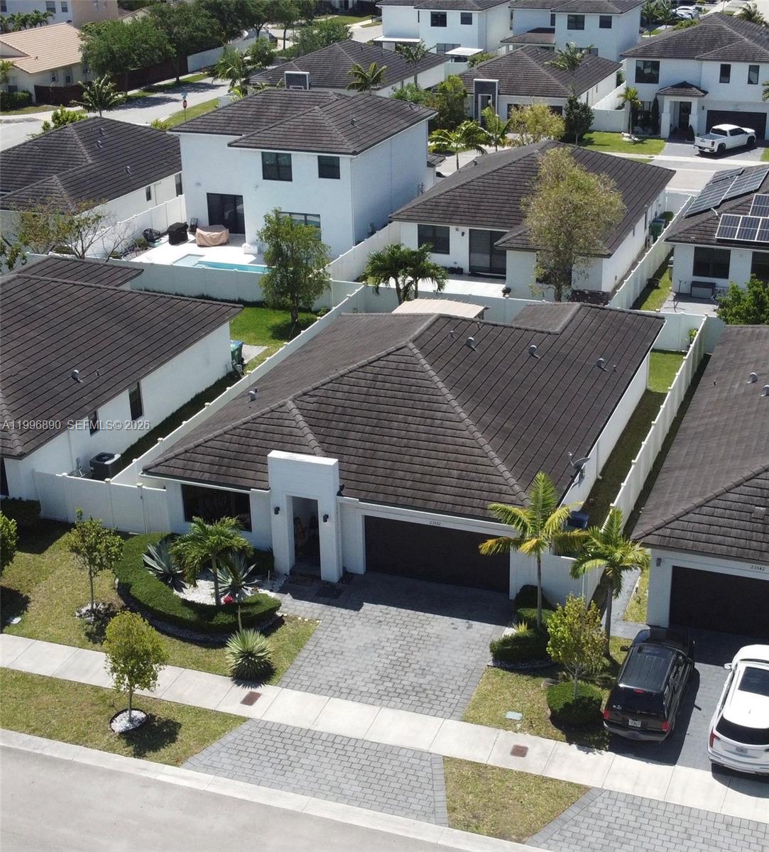 23552 Southwest 107th Place Homestead, FL 33032 - Photo 5 of 30 a aerial view of a house with a garden and parking spaces