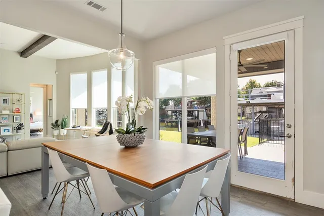a dining room with furniture a chandelier and wooden floor