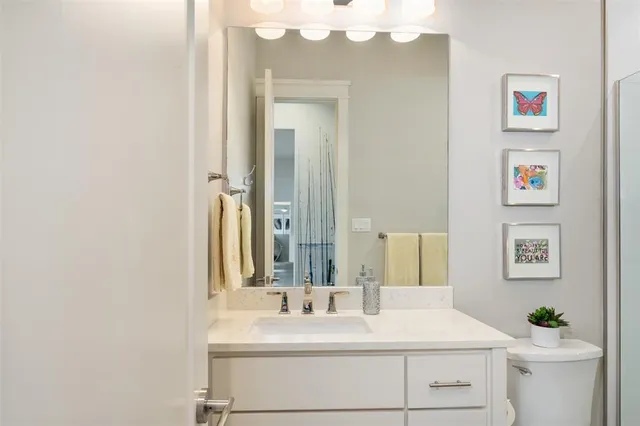 a bathroom with a sink vanity and a mirror