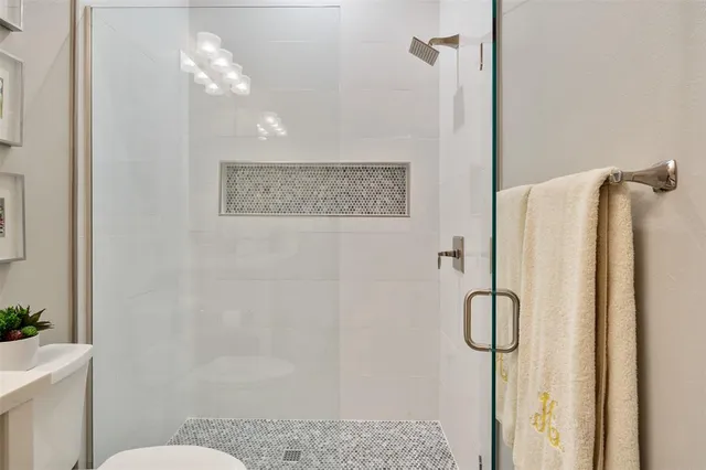 a bathroom with a shower a toilet and a sink