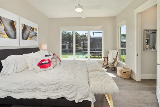 a bedroom with a bed and glass walk in closet