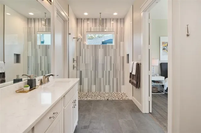 a bathroom with a double vanity sink mirror and shower