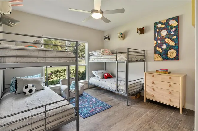 a bedroom with a bed dresser and window