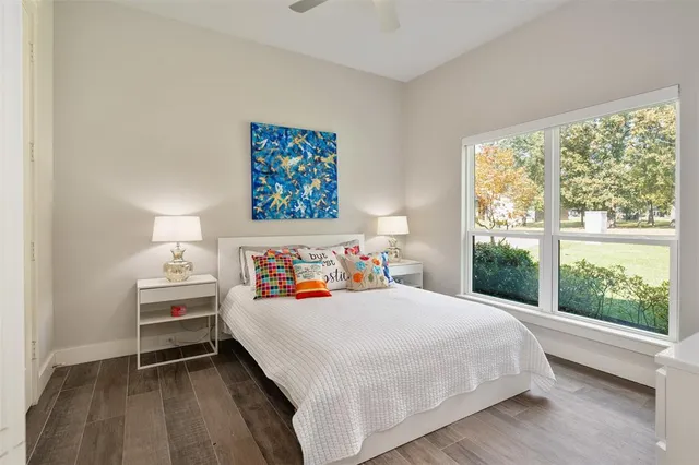 a bedroom with a bed and a large window