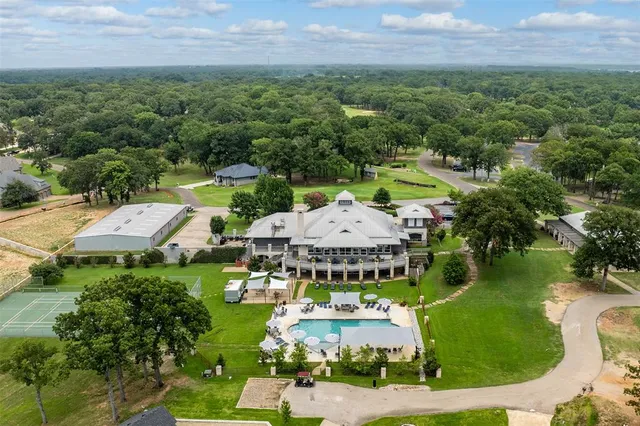 an aerial view of a house with a garden and lake view