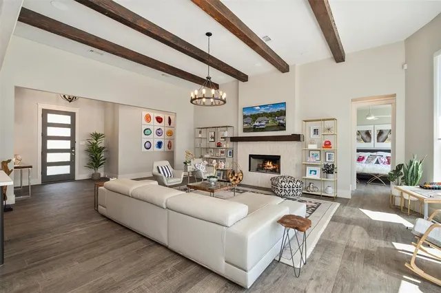 a living room with furniture a fireplace and a large mirror