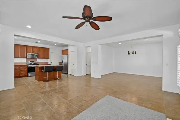 a view of a livingroom with a fireplace and a ceiling fan