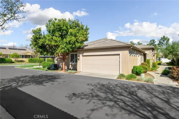 a front view of a house with a yard and a garage