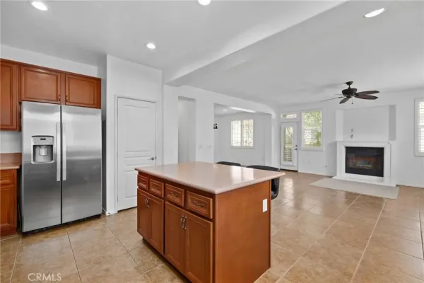 a kitchen with stainless steel appliances granite countertop a refrigerator a sink and a stove
