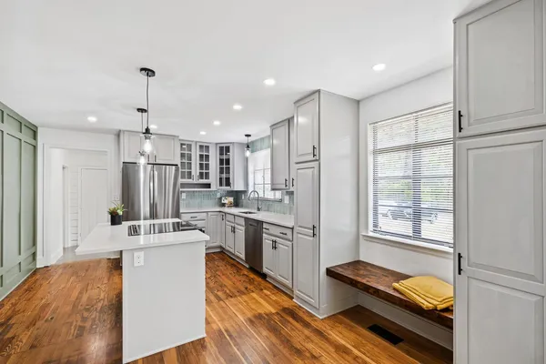 a kitchen with refrigerator a stove and a kitchen island