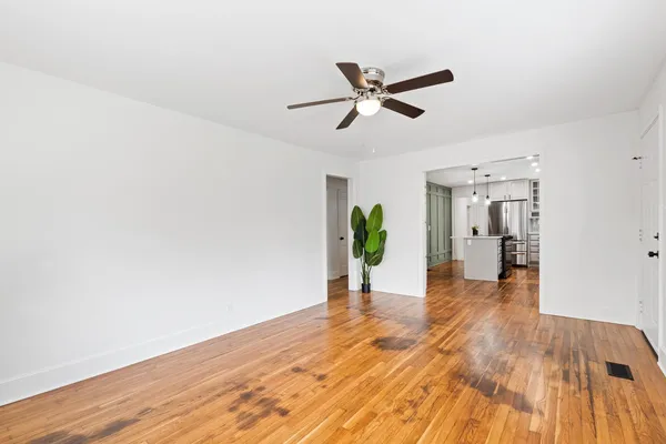 a view of a hallway view with wooden floor and staircase