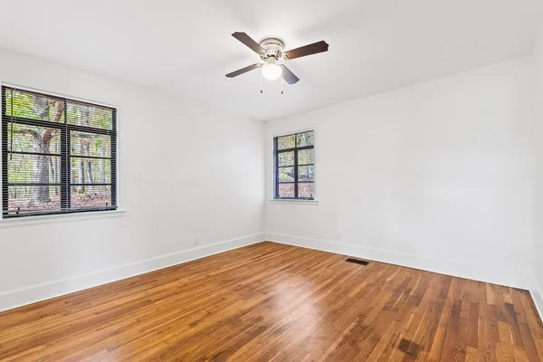 wooden floor in an empty room with a window