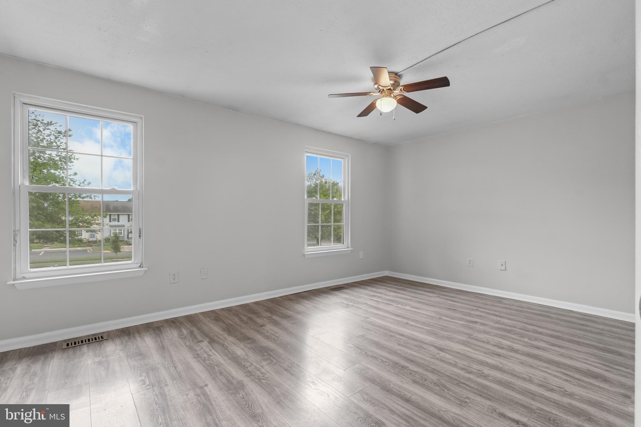 8729 Ritchboro Road District Heights, MD 20747 - Photo 11 of 22 a view of empty room with wooden floor and fan