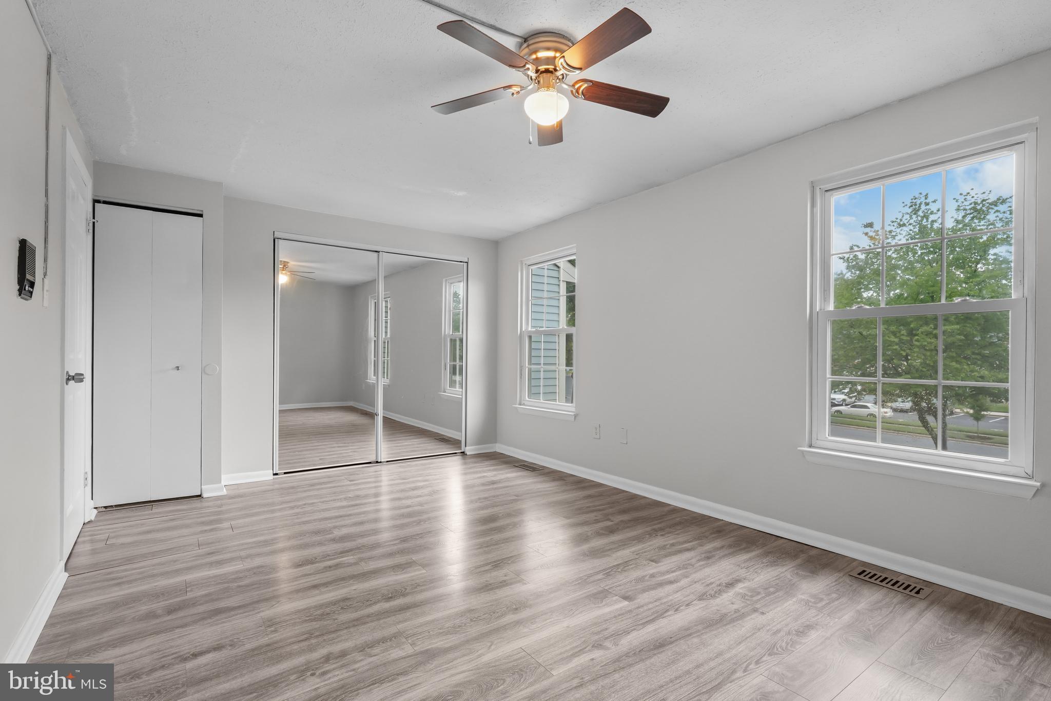 8729 Ritchboro Road District Heights, MD 20747 - Photo 12 of 22 a view of an empty room with window and wooden floor