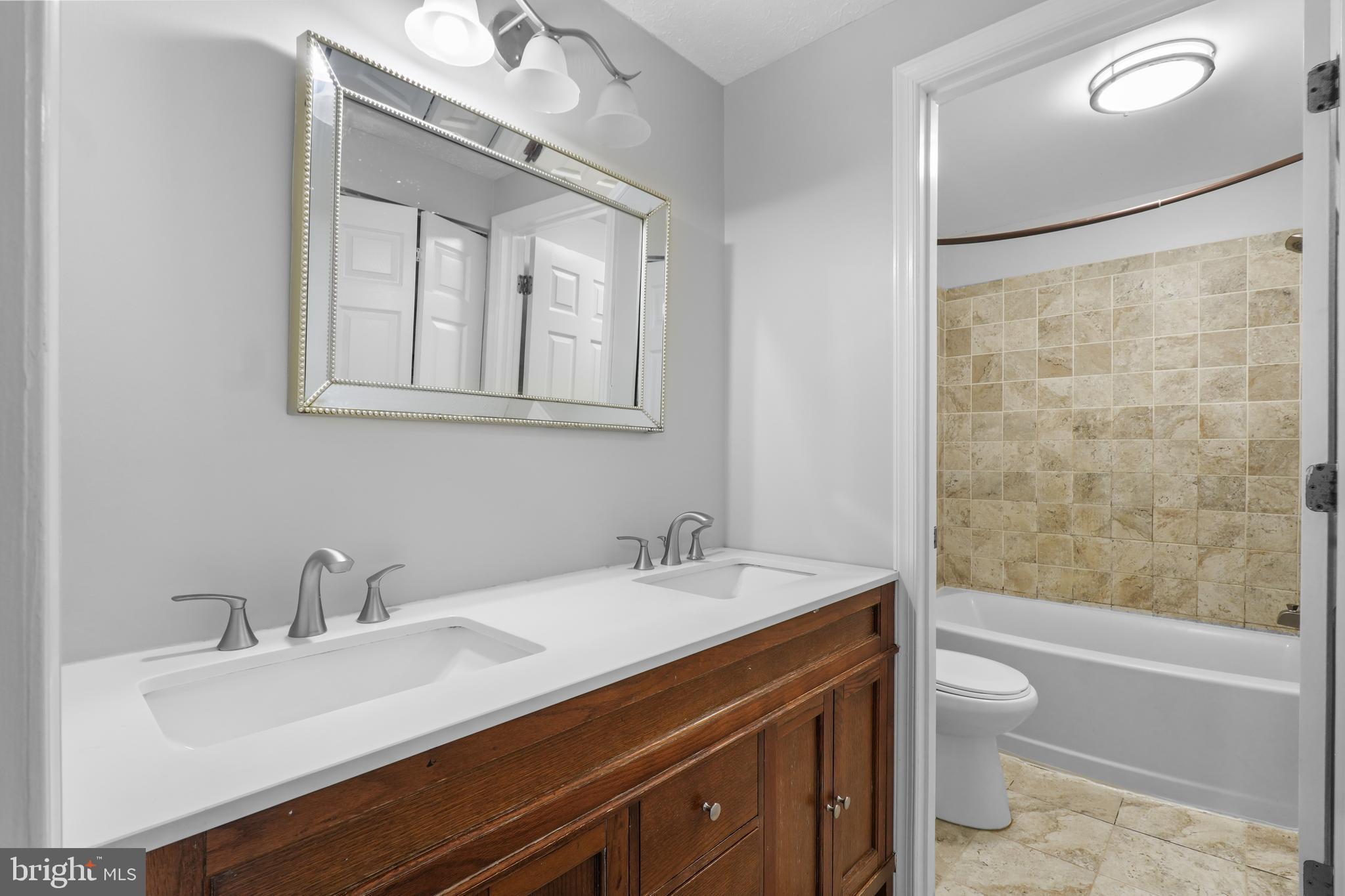 8729 Ritchboro Road District Heights, MD 20747 - Photo 13 of 22 a bathroom with a sink and a mirror