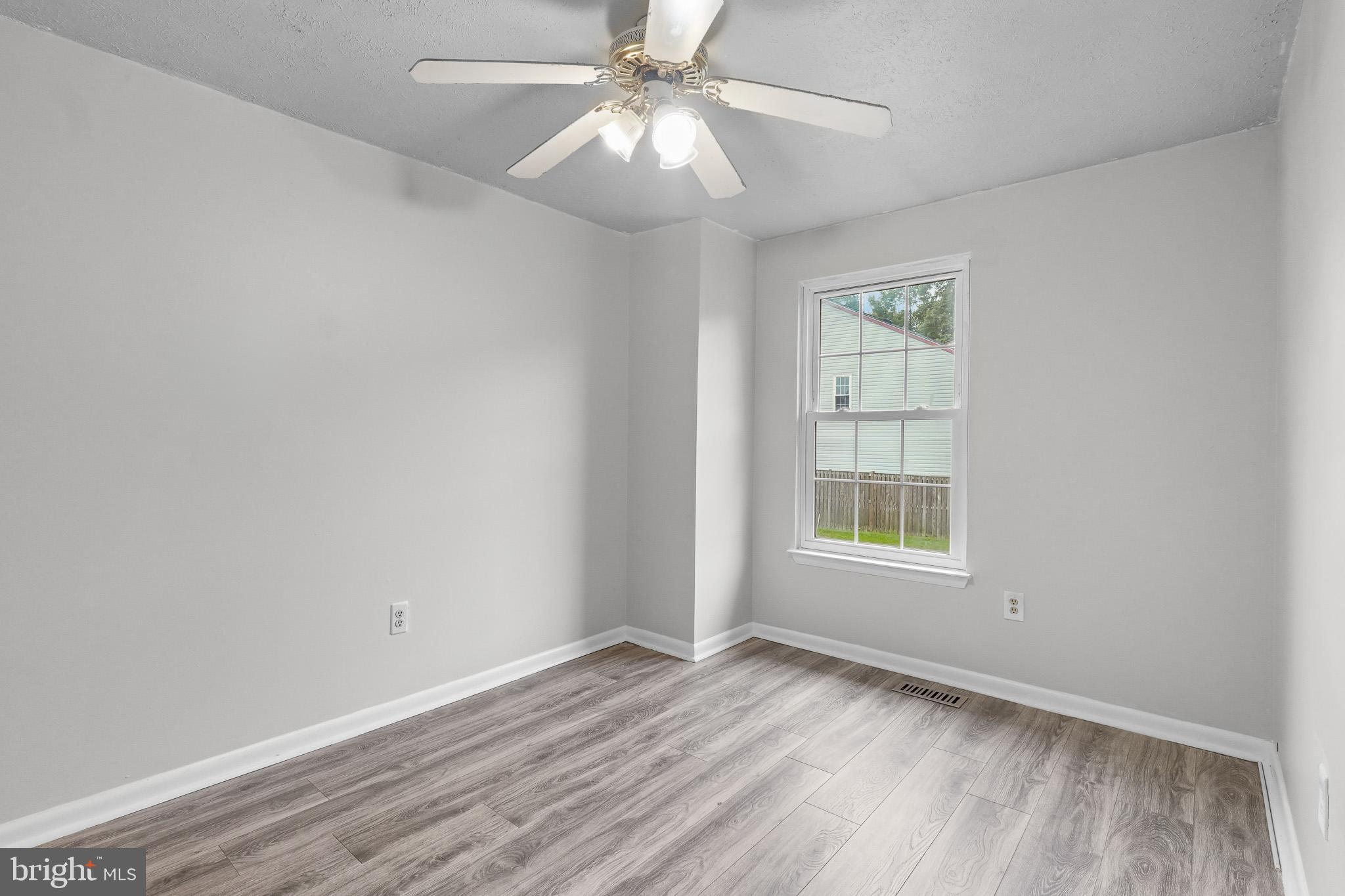 8729 Ritchboro Road District Heights, MD 20747 - Photo 17 of 22 an empty room with a window and a fan