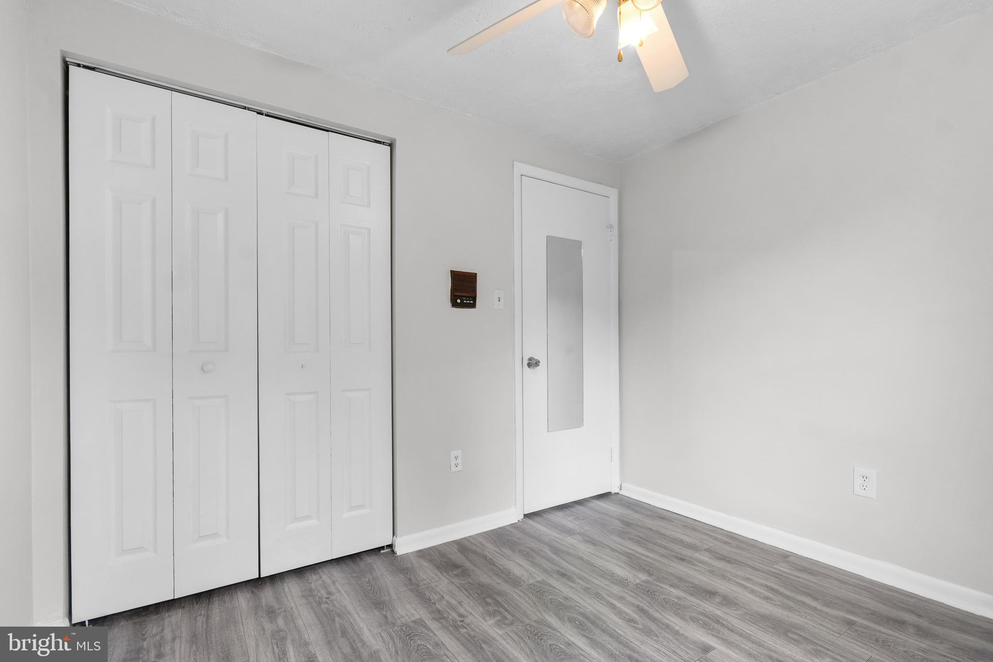 8729 Ritchboro Road District Heights, MD 20747 - Photo 18 of 22 a view of an empty room with wooden floor and windows