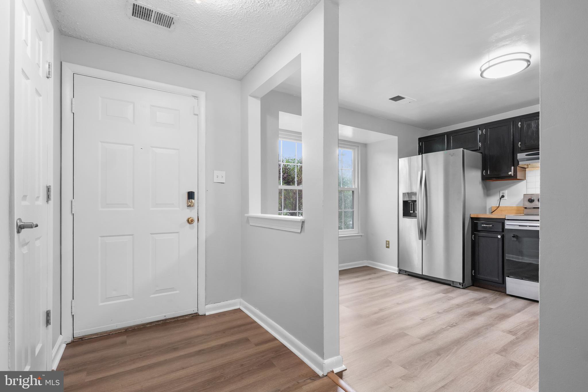 8729 Ritchboro Road District Heights, MD 20747 - Photo 2 of 22 a view of a kitchen with a refrigerator and a stove top oven
