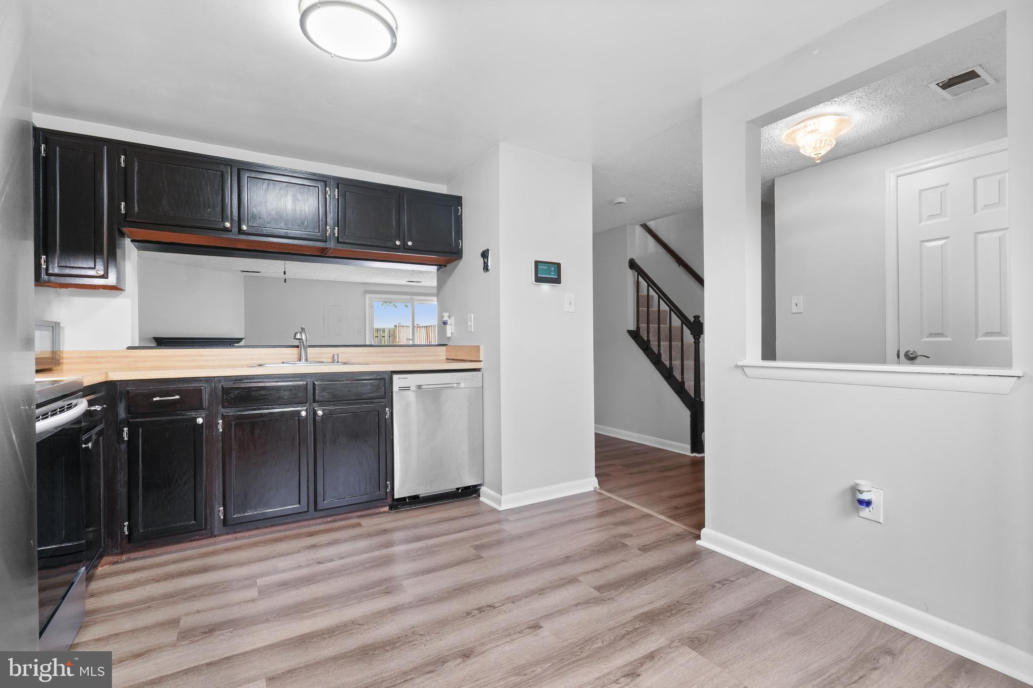 8729 Ritchboro Road District Heights, MD 20747 - Photo 5 of 22 a kitchen with stainless steel appliances granite countertop a stove and a sink