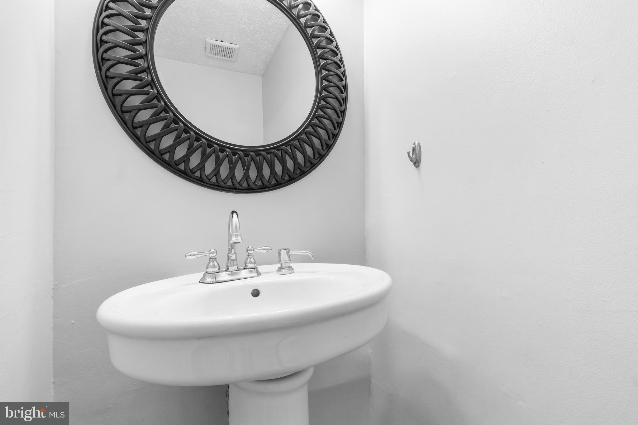 8729 Ritchboro Road District Heights, MD 20747 - Photo 6 of 22 a bathroom with a sink and a mirror