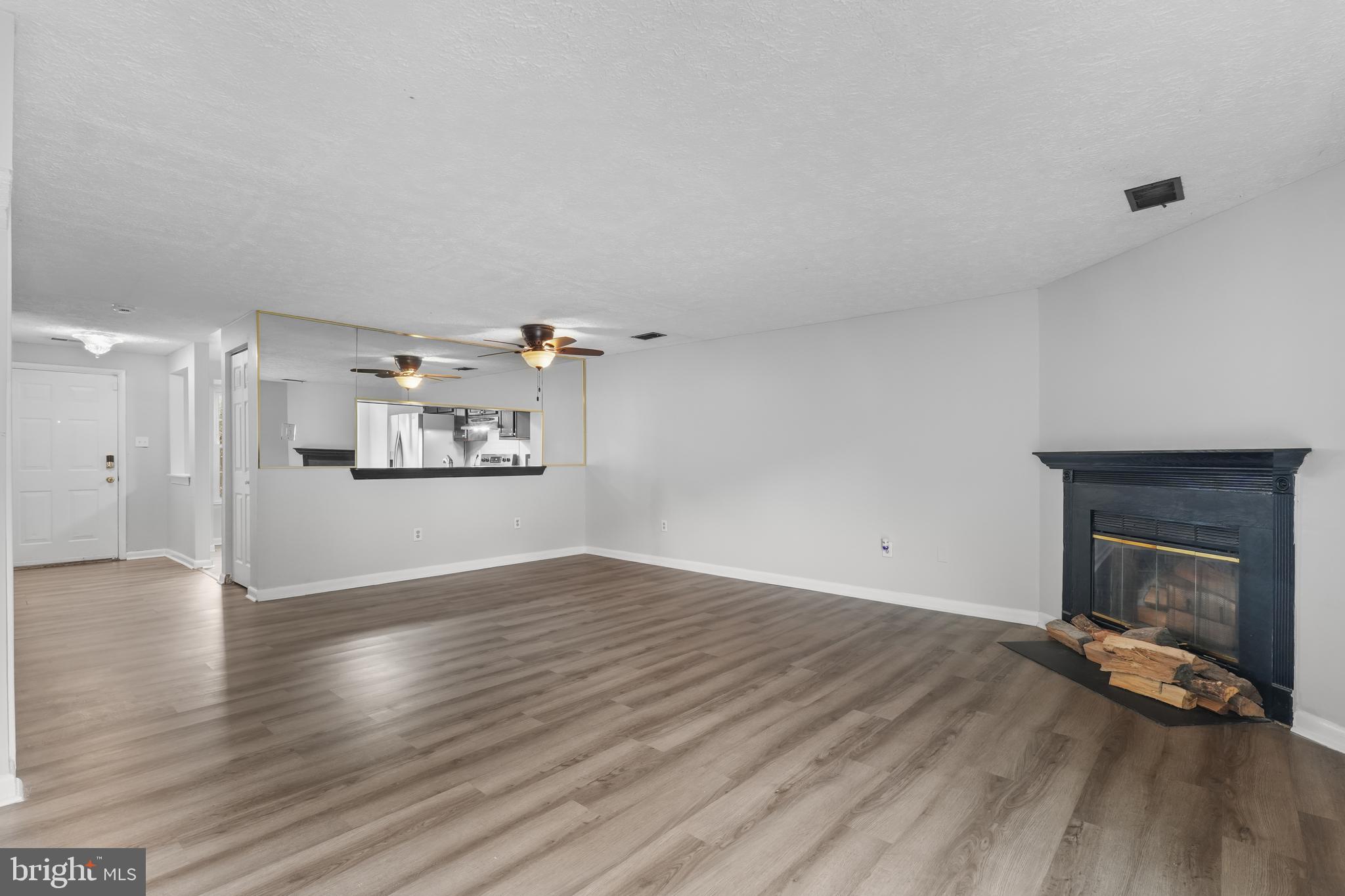 8729 Ritchboro Road District Heights, MD 20747 - Photo 7 of 22 a view of empty room with wooden floor and fireplace