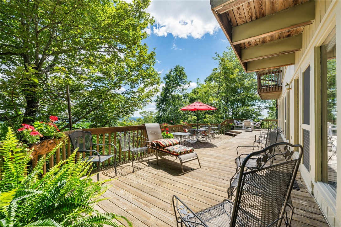 2177 Homestead Road Todd, NC 28684 - Photo 28 of 49 a view of a patio with couches table and chairs and potted plants