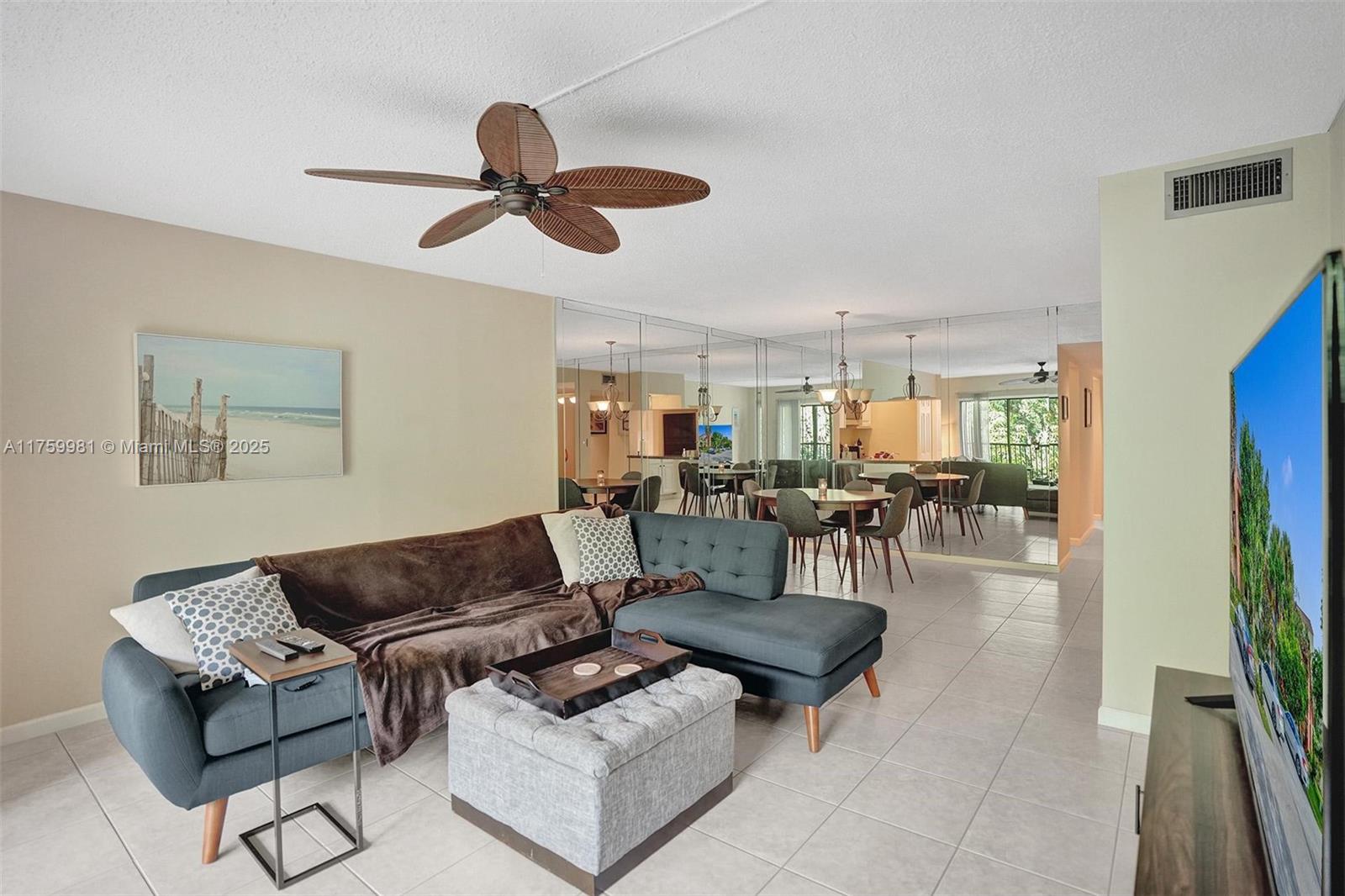 1786 Hammock Boulevard, Unit 218 Coconut Creek, FL 33063 - Photo 1 of 47 a living room with furniture and a view of kitchen
