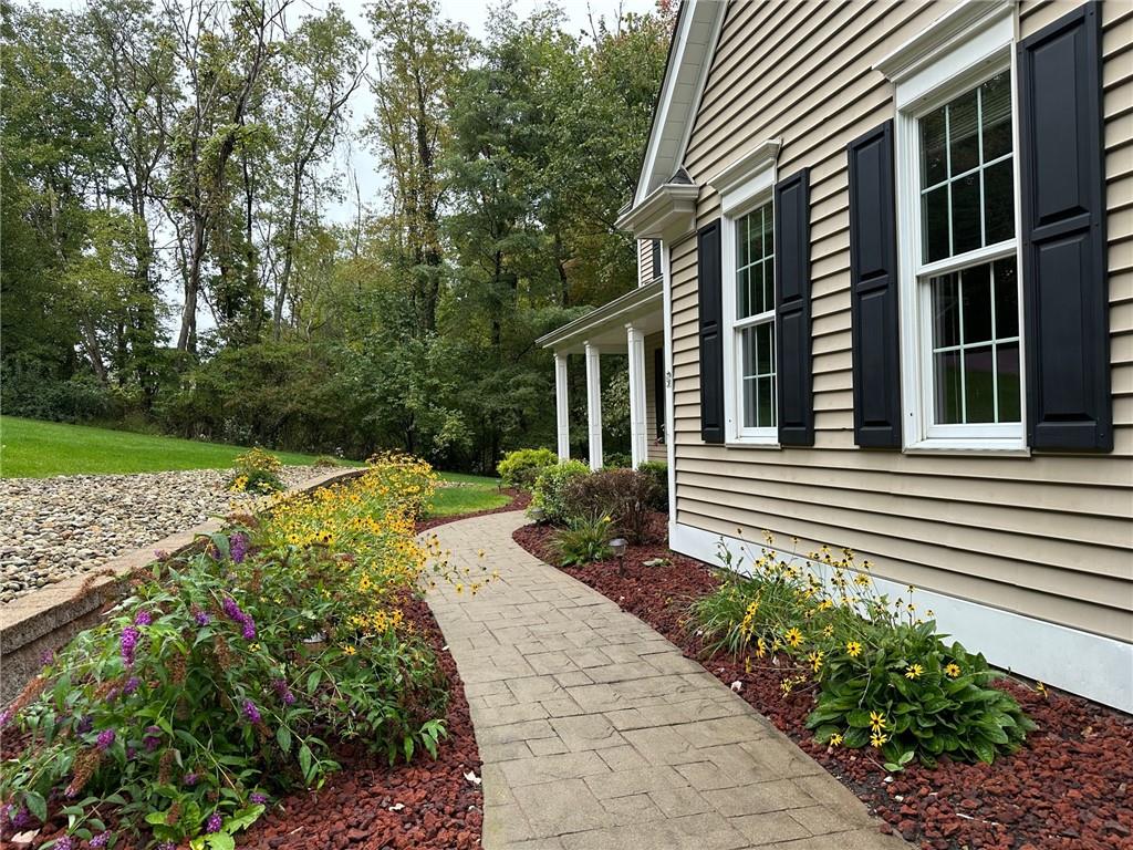235 Stoup Road Mars, PA 16046 - Photo 4 of 50 a view of a house with a yard and flower garden