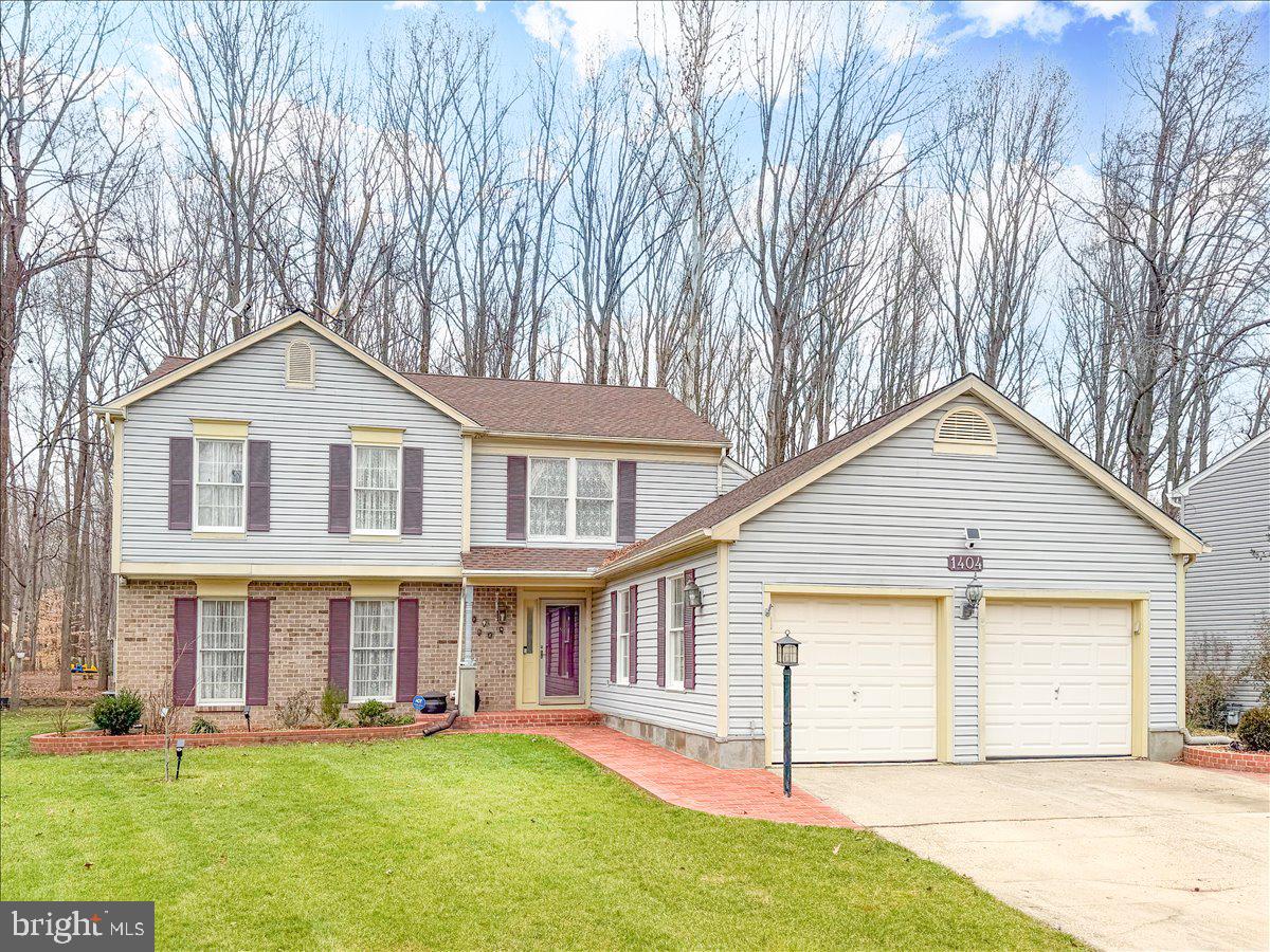 1404 Partridge Lane Bowie, MD 20721 - Photo 1 of 78 a front view of a house with a yard and garage