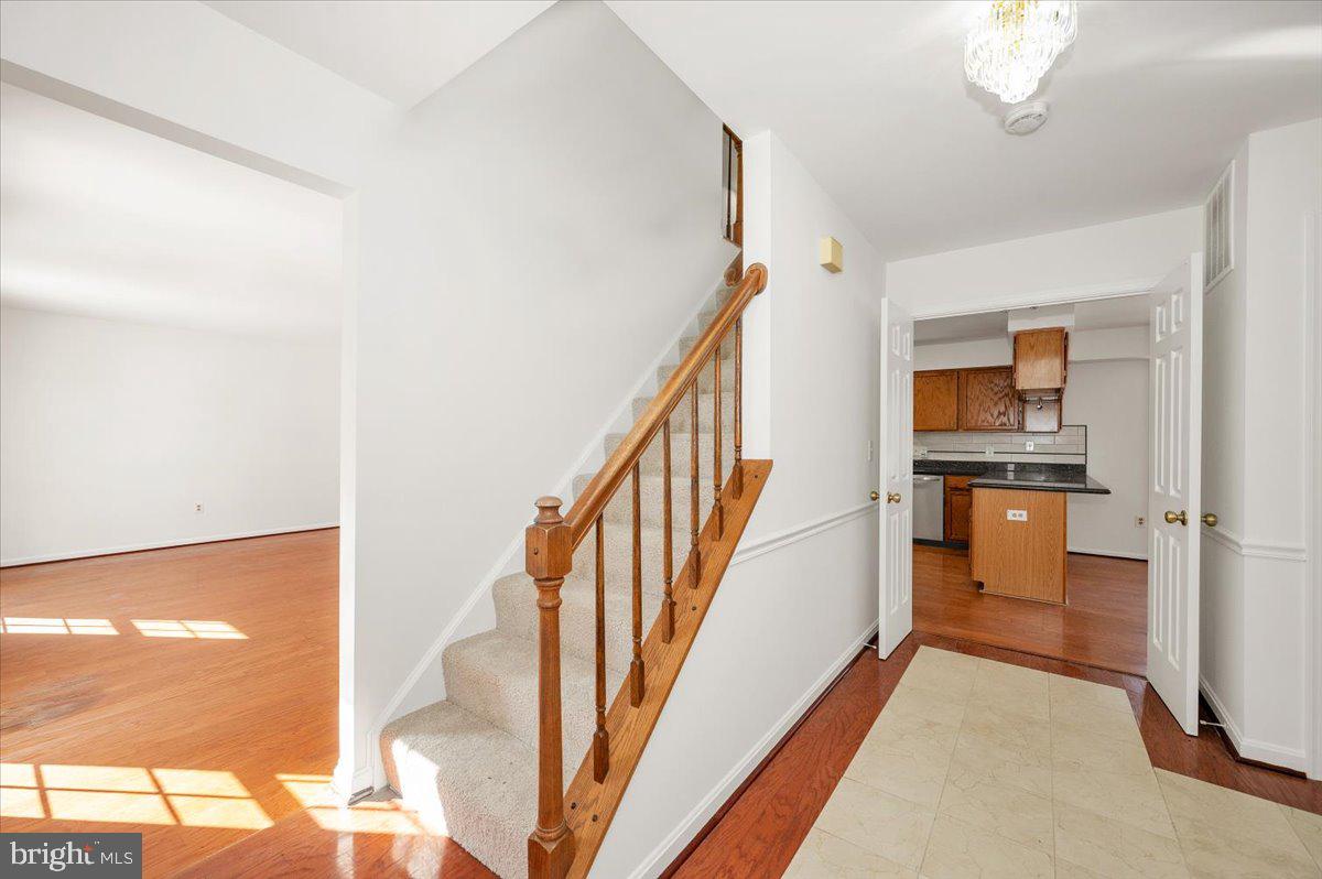 1404 Partridge Lane Bowie, MD 20721 - Photo 12 of 78 a view of a hallway with wooden floor and staircase