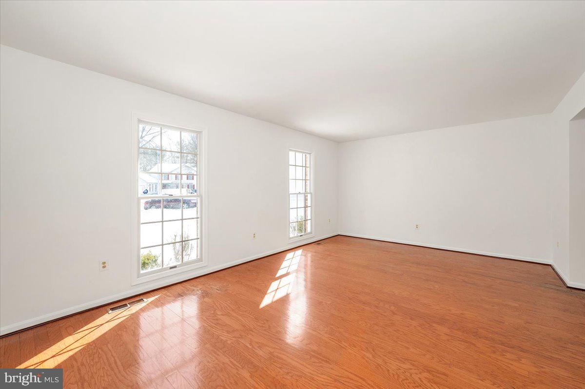 1404 Partridge Lane Bowie, MD 20721 - Photo 13 of 78 an empty room with wooden floor and windows