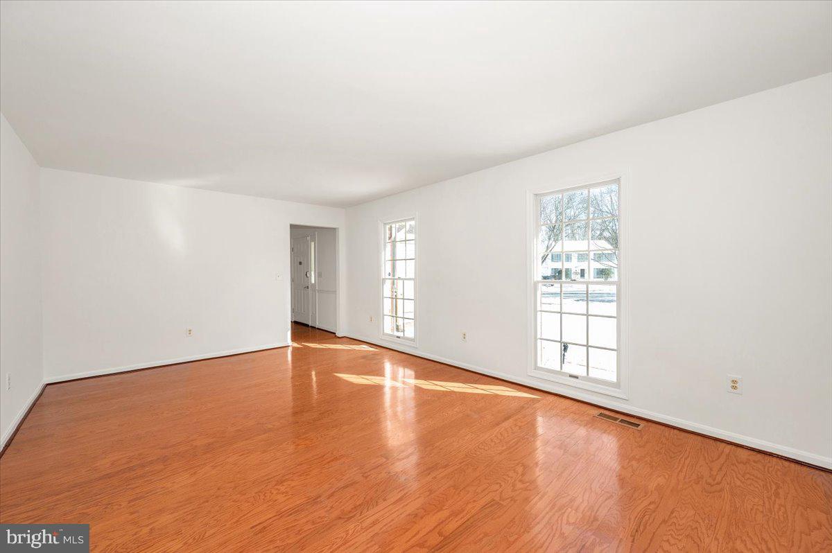 1404 Partridge Lane Bowie, MD 20721 - Photo 16 of 78 an empty room with wooden floor and windows