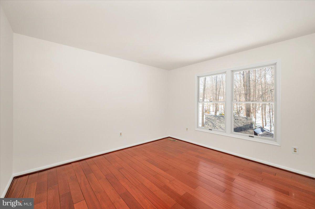 1404 Partridge Lane Bowie, MD 20721 - Photo 30 of 78 an empty room with wooden floor and windows