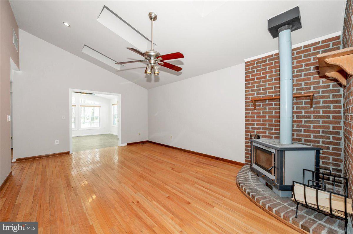1404 Partridge Lane Bowie, MD 20721 - Photo 32 of 78 a view of an empty room with wooden floor and a ceiling fan