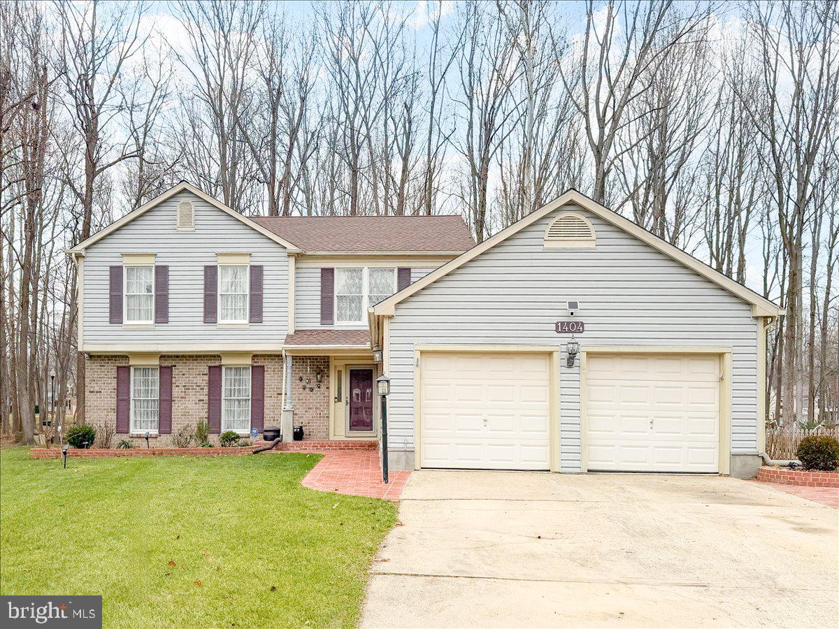 1404 Partridge Lane Bowie, MD 20721 - Photo 4 of 78 a front view of a house with a yard and garage