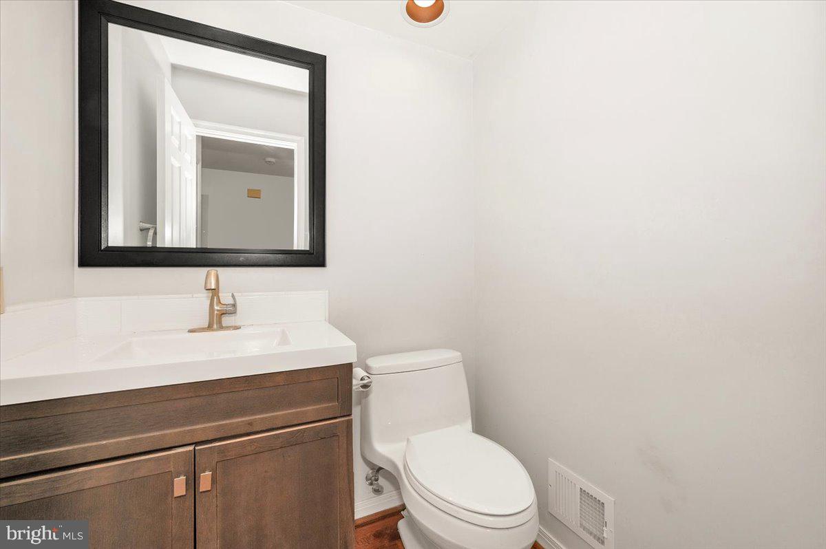 1404 Partridge Lane Bowie, MD 20721 - Photo 41 of 78 a bathroom with a toilet a sink and mirror