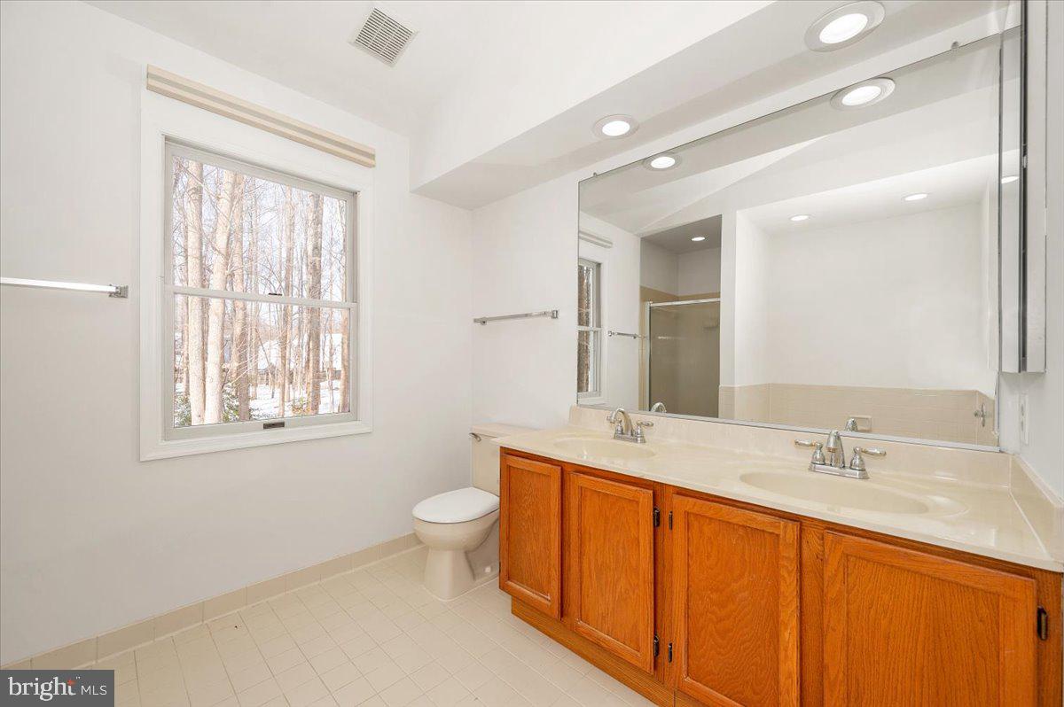 1404 Partridge Lane Bowie, MD 20721 - Photo 47 of 78 a bathroom with a toilet sink and mirror