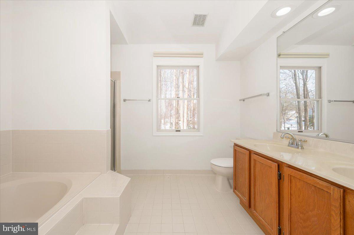 1404 Partridge Lane Bowie, MD 20721 - Photo 48 of 78 a bathroom with a sink a toilet and tub