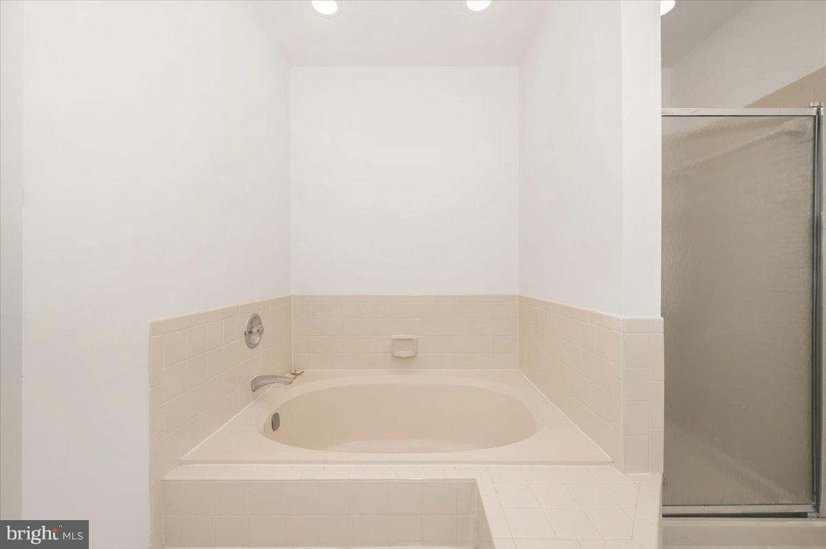 1404 Partridge Lane Bowie, MD 20721 - Photo 58 of 78 a white bath tub sitting next to a white sink and vanity