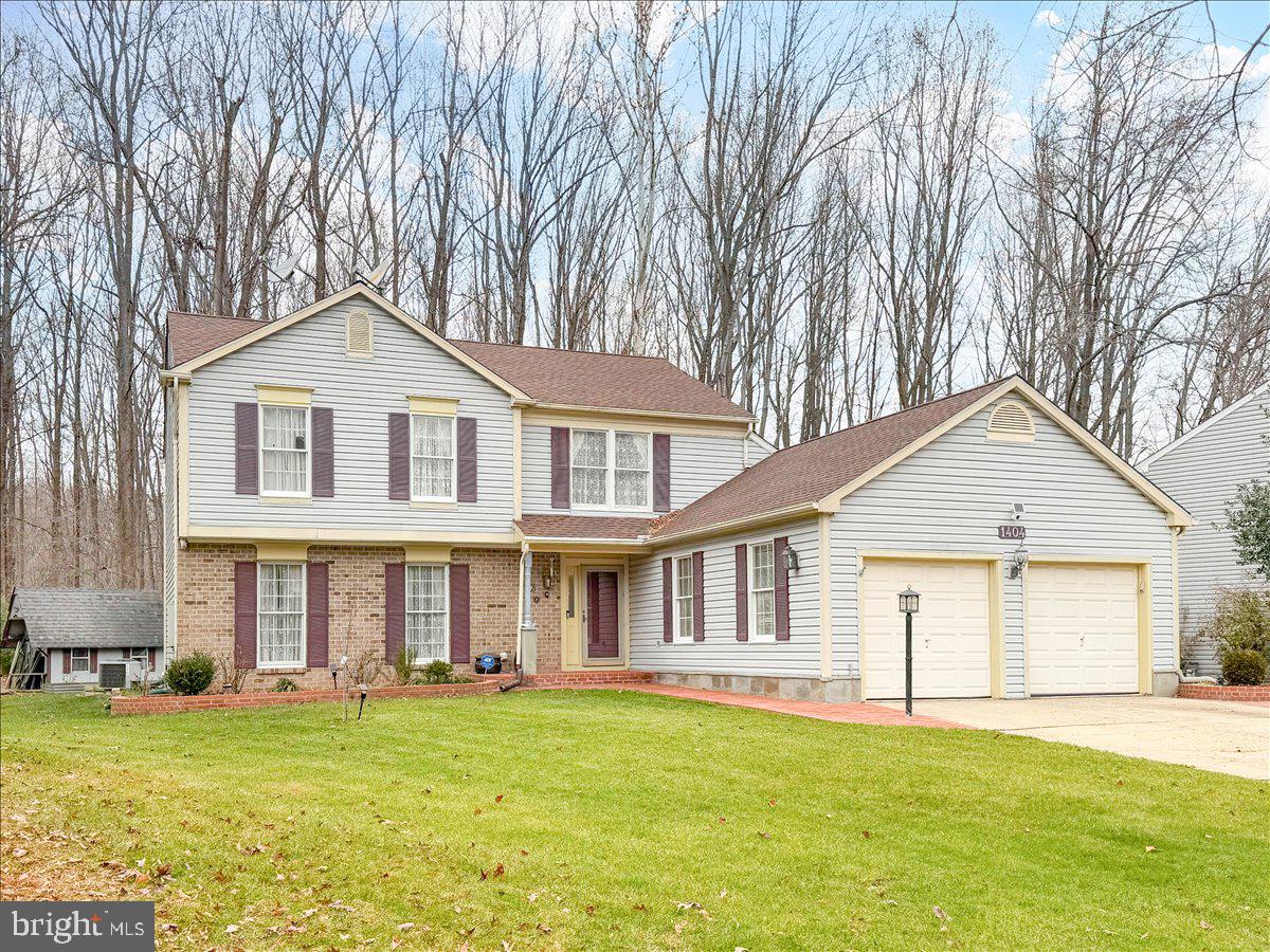 1404 Partridge Lane Bowie, MD 20721 - Photo 6 of 78 a front view of a house with a garden