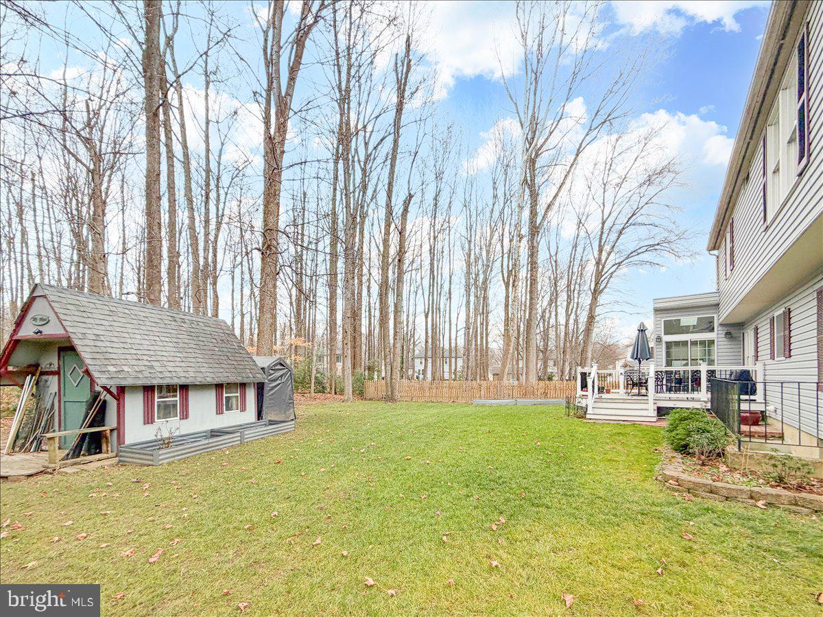 1404 Partridge Lane Bowie, MD 20721 - Photo 7 of 78 a view of a house with a big yard and large trees