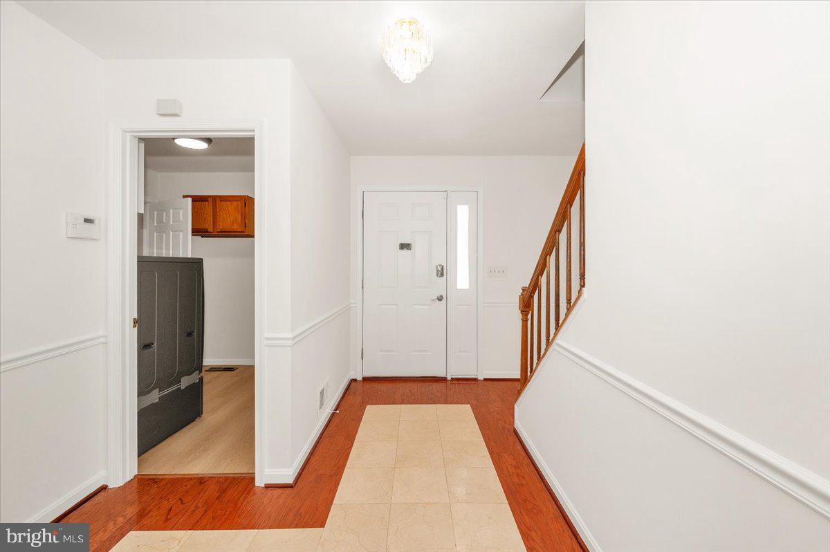 1404 Partridge Lane Bowie, MD 20721 - Photo 10 of 78 a view of a hallway with wooden floor and staircase
