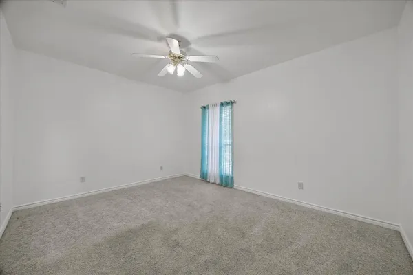 an empty room with a fan & a fan