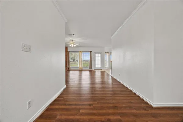 a view of an entryway with wooden floor