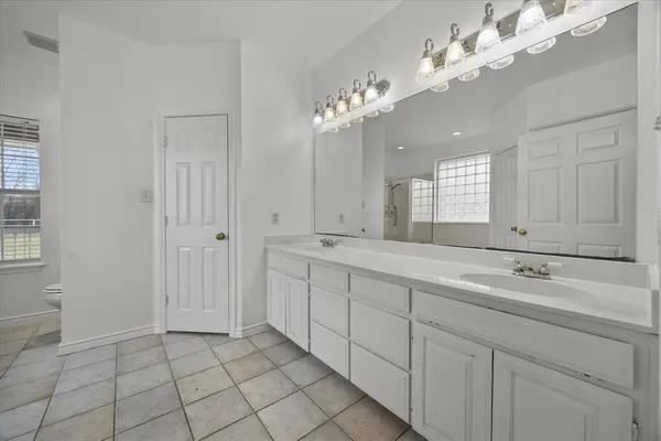a bathroom with a sink a double vanity and a mirror