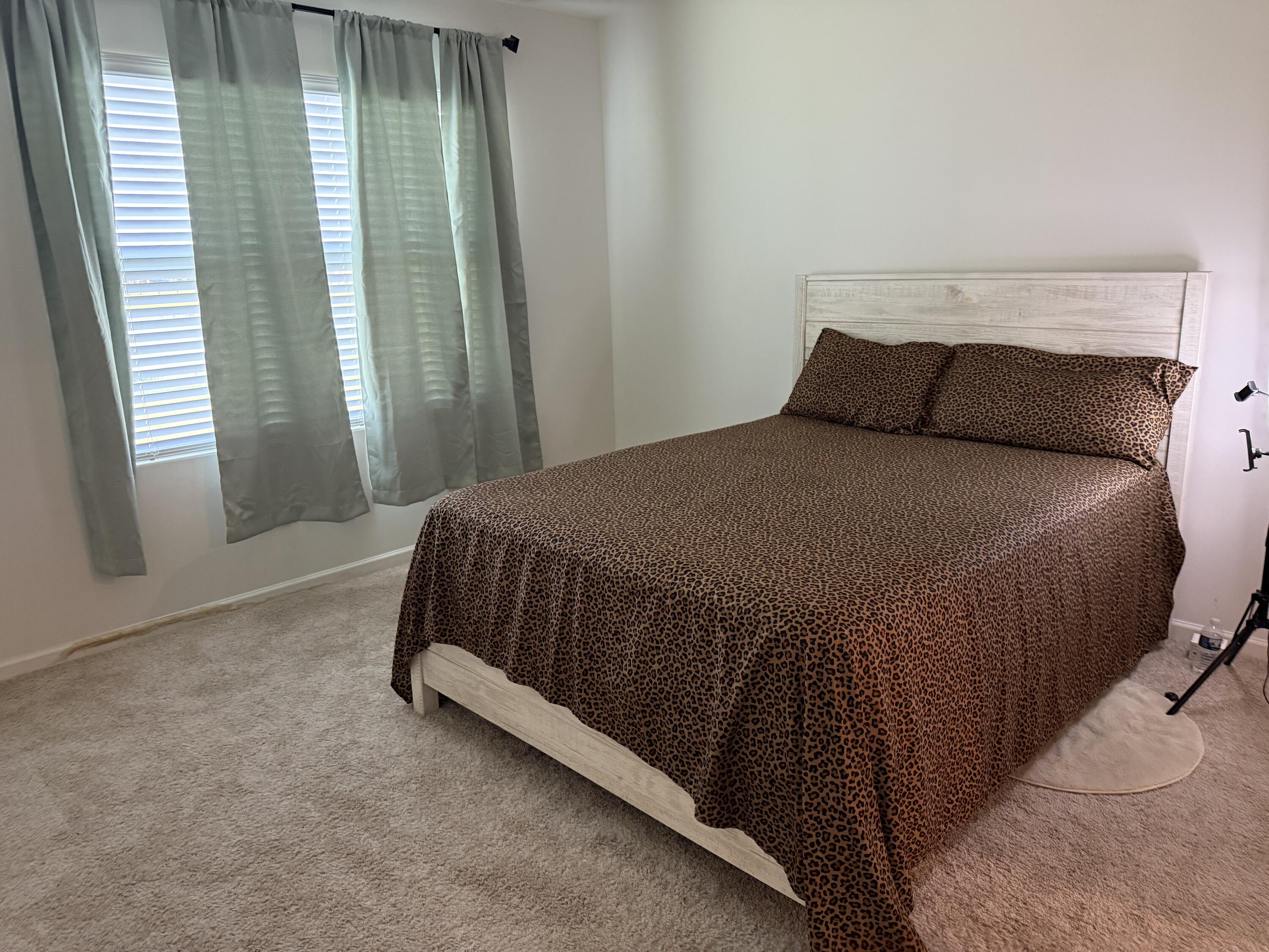 9511 Potomac Drive Fort Pierce, FL 34945 - Photo 15 of 26 a bed sitting in a bedroom next to a window