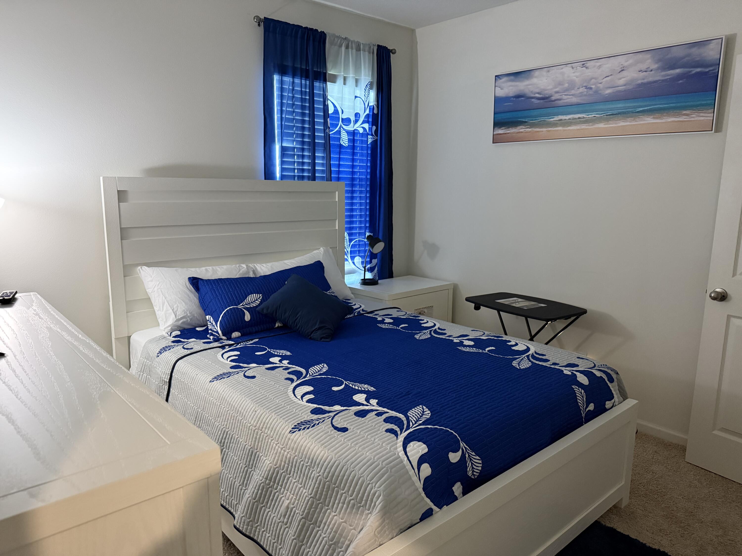 9511 Potomac Drive Fort Pierce, FL 34945 - Photo 2 of 26 a bed sitting in a bedroom next to a window