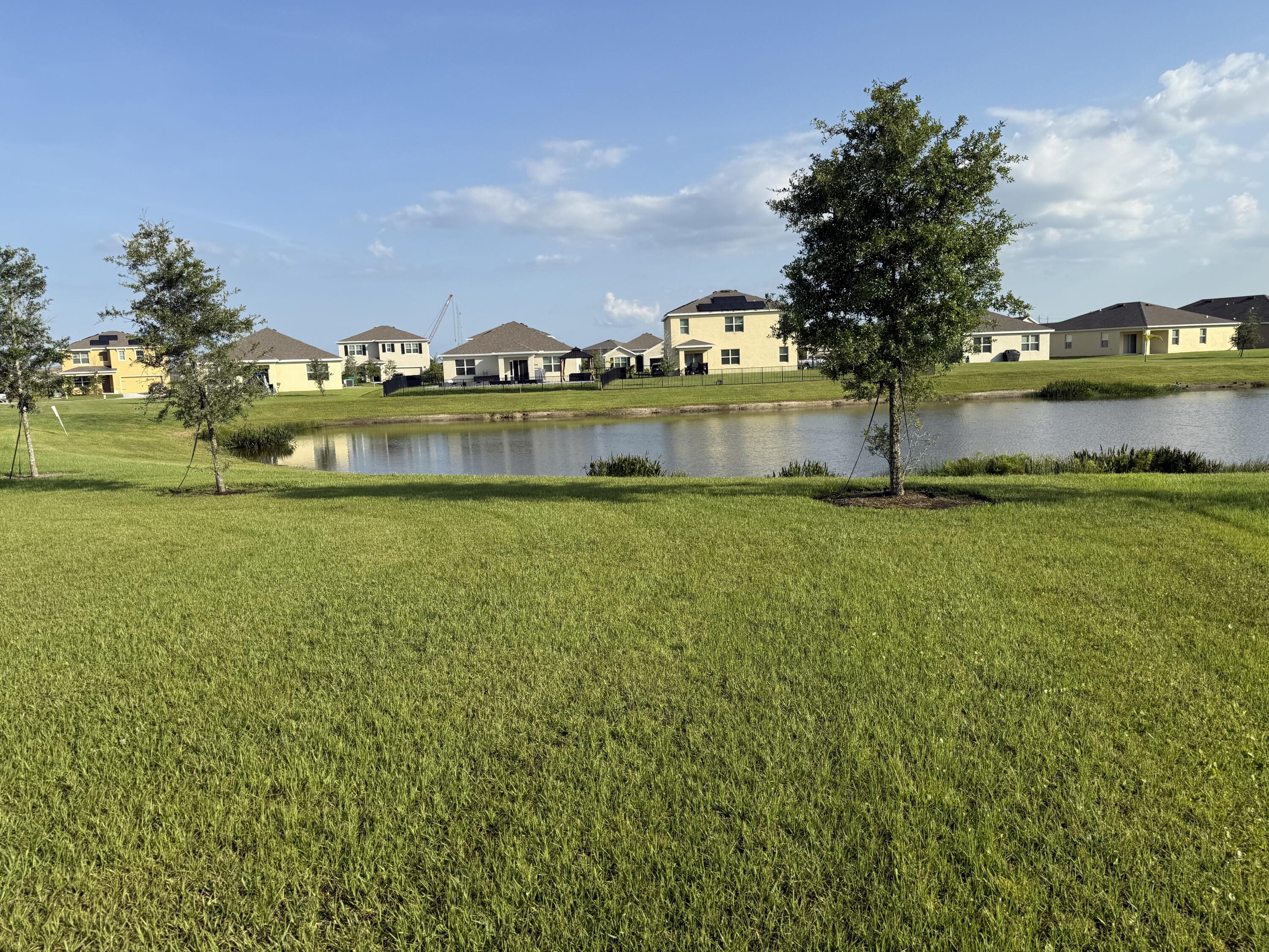 9511 Potomac Drive Fort Pierce, FL 34945 - Photo 24 of 26 a view of a lake with houses